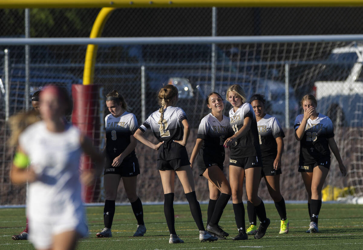 Faith Lutheran players celebrate after defeating Arbor View 2-1 during a girls high school socc ...
