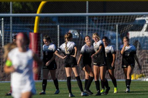 Faith Lutheran players celebrate after defeating Arbor View 2-1 during a girls high school socc ...