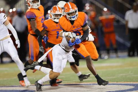 Bishop Gorman's Zion Branch (5) is tackled by Lone Peak's Spencer Fotu (7) after a run in the s ...