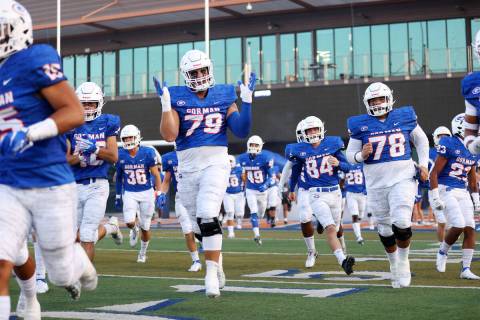 Bishop Gorman players including Jake Taylor (79) take the field for their football game against ...