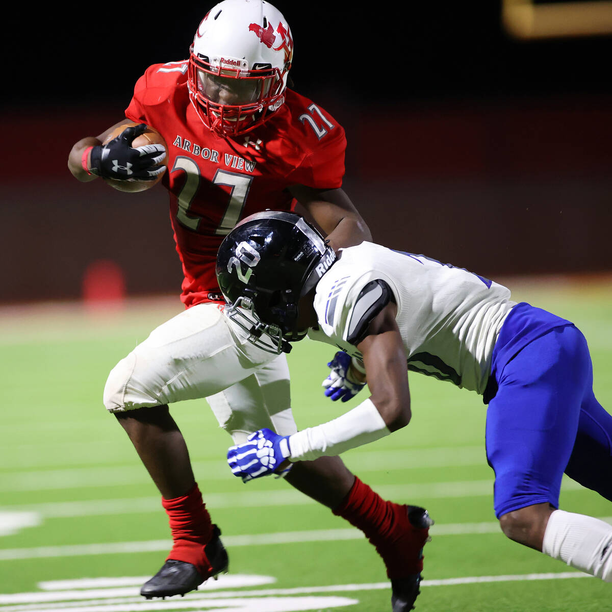 Arbor View's Makhai Donaldson (27) runs the ball before getting tackled by Desert Pines Isaiah ...