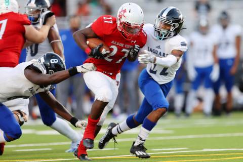 Arbor View's Makhai Donaldson (27) runs the ball before getting tackled by Desert Pines Labarri ...
