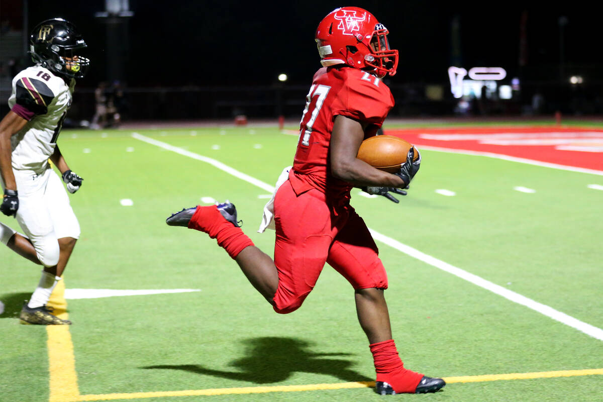 Arbor View's Makhai Donaldson (27) runs for a touchdown as Faith Lutheran's Cam'ren-chance Bro ...