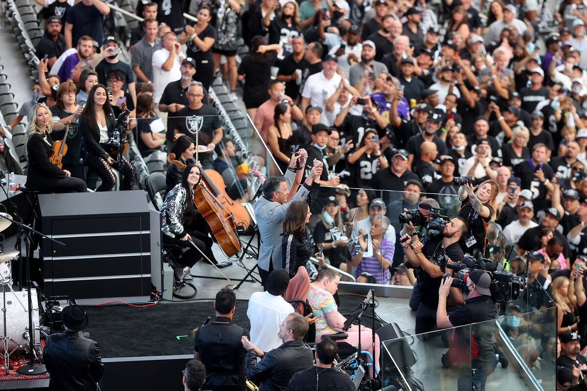 Former Nevada Gov. Brian Sandoval, center, lights the Al Davis Memorial Torch before the Raider ...