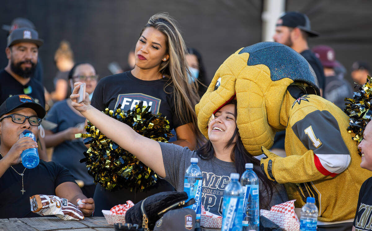 Chance the Gila monster bites the head of Amanda Lopez during the Golden Knights annual Fan Fes ...