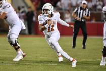 Texas quarterback Casey Thompson (11) runs the ball against Arkansas during an NCAA college foo ...
