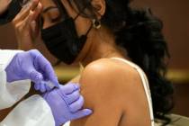 Selam Shumie, a cocktail server at Resorts World Las Vegas, receives her COVID-19 vaccination d ...