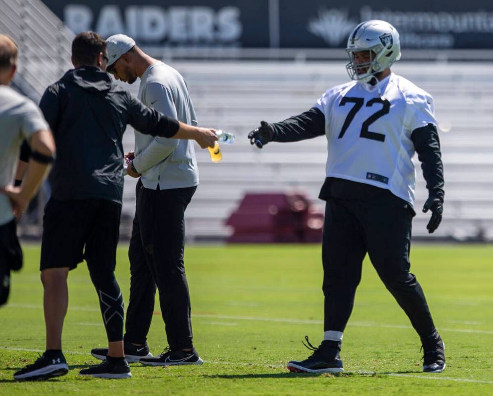 Raiders offensive tackle Jermaine Eluemunor (72) grabs a water during team practice at the Raid ...