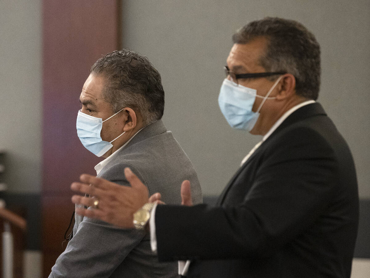 Omar Rueda-Denvers, left, listens as his attorney Christopher Oram speaks during Denvers’ ret ...