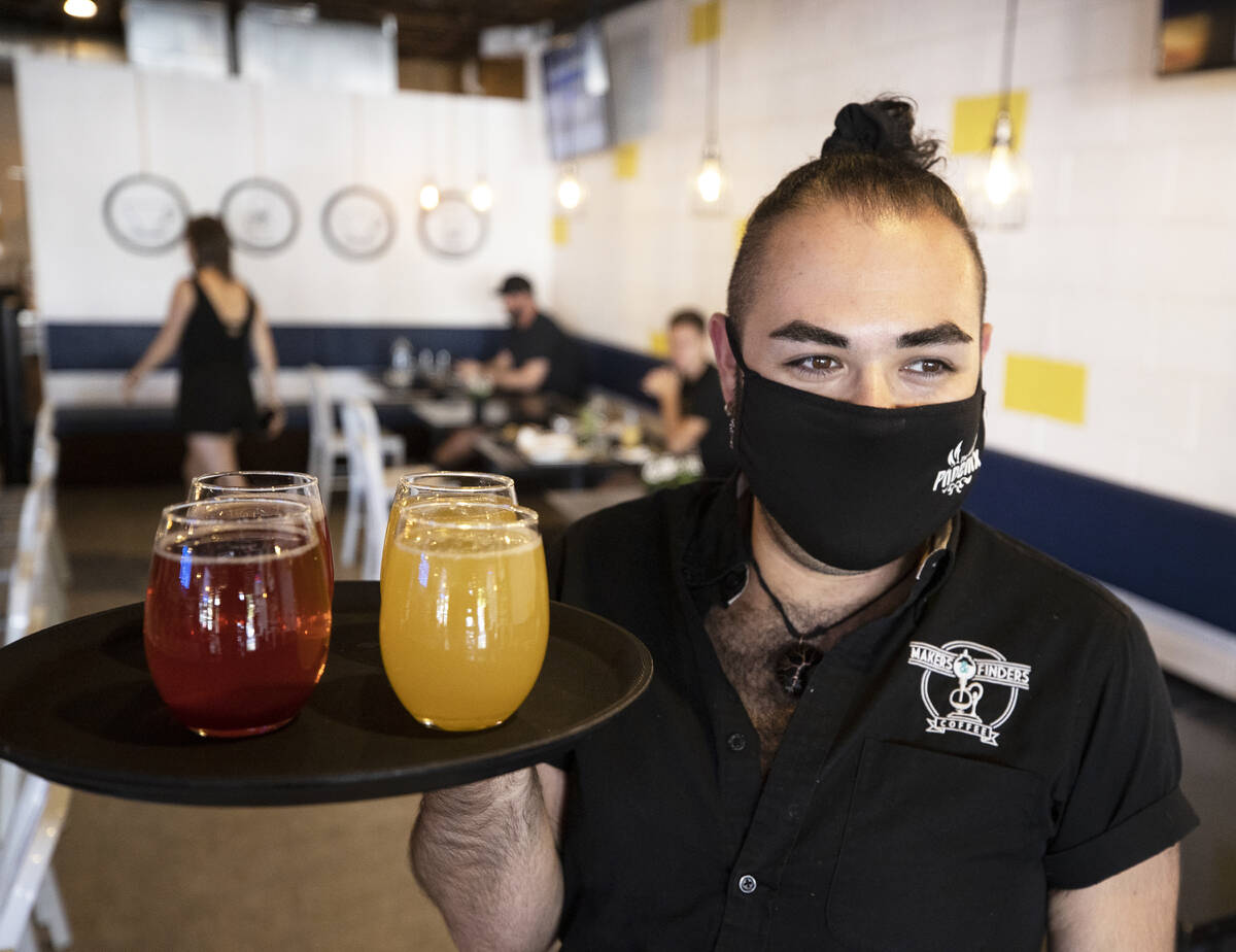 Server Julian Galvan brings drinks to a table at Makers & Finders on Wednesday, Sept. 15, 2 ...