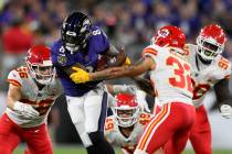 Baltimore Ravens quarterback Lamar Jackson (8) rushes against Kansas City Chiefs defenders in t ...