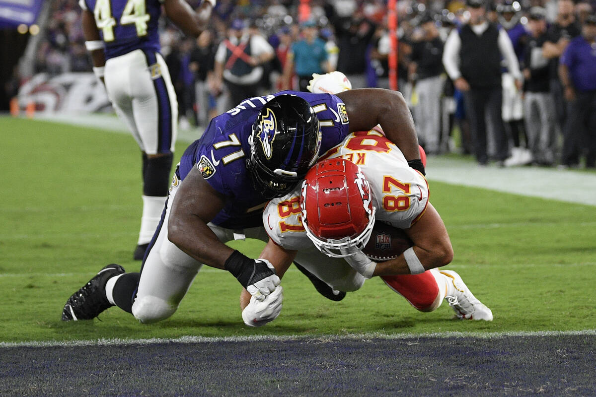Kansas City Chiefs tight end Travis Kelce (87) scores a touchdown in front of Baltimore Ravens ...