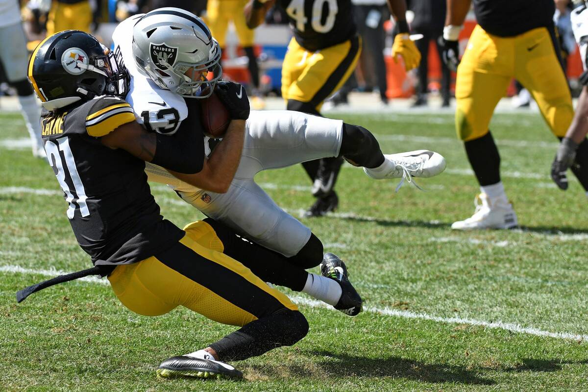 Las Vegas Raiders wide receiver Hunter Renfrow (13) is tackled by Pittsburgh Steelers cornerbac ...