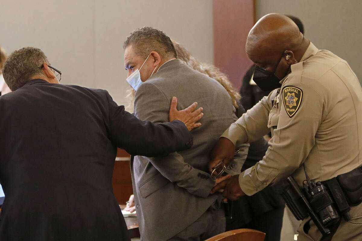 Attorney Christopher Oram, left, talks to Omar Rueda-Denvers, center, after Rueda-Denvers was f ...