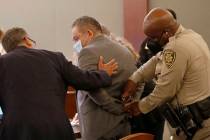 Attorney Christopher Oram, left, talks to Omar Rueda-Denvers, center, after Rueda-Denvers was f ...