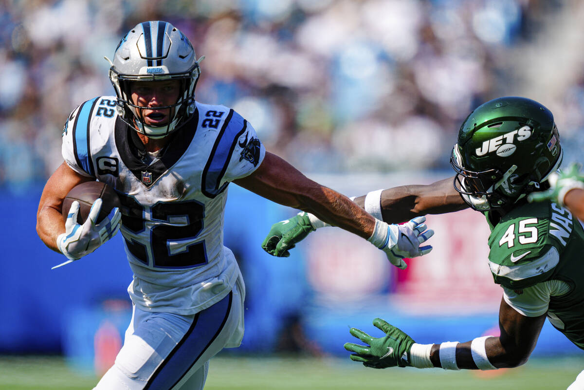 Carolina Panthers running back Christian McCaffrey pushes away New York Jets linebacker Hamsah ...