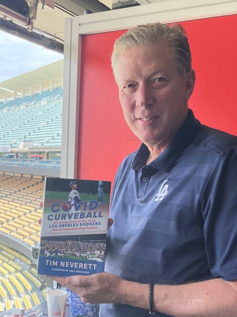 Former Dodgers pitching great Orel Hershiser holds a copy of Tim Neverett's book about the Dodg ...