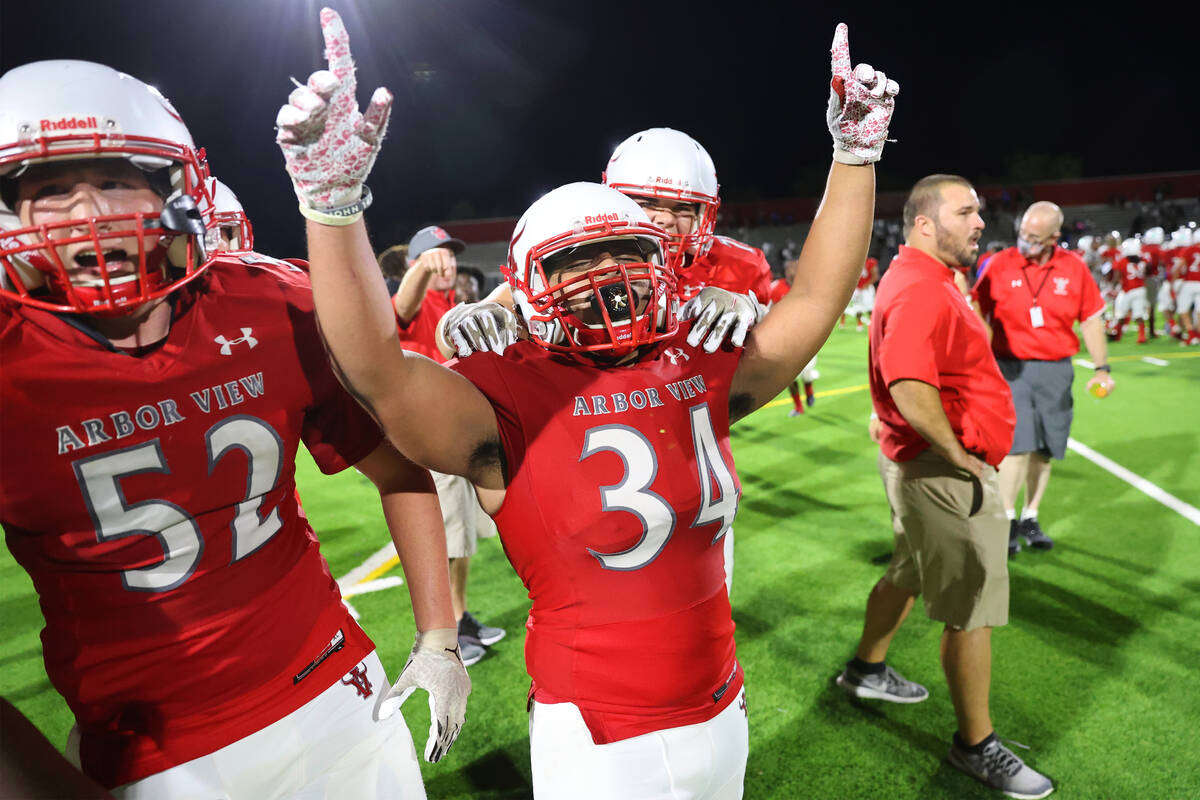 Arbor View's Gage Williams (52) and Jaden Jackson (34) celebrate their win against Desert Pines ...