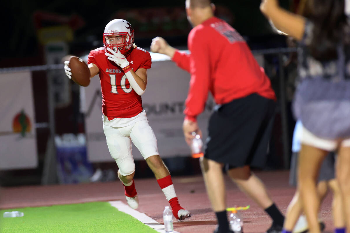 Arbor View's Logan Clogston (10) celebrates after making a catch in the end zone for a 2-point ...