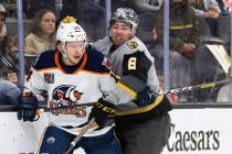 Henderson Silver Knights forward Jack Dugan (8) collides with Bakersfield Condors left wing Dev ...