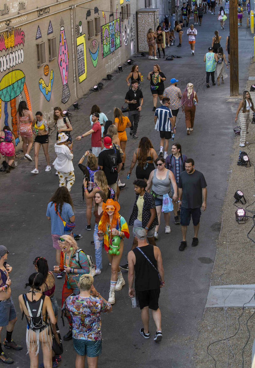 People walk along an alley off of Fremont Street painted with new art during day one of Life is ...