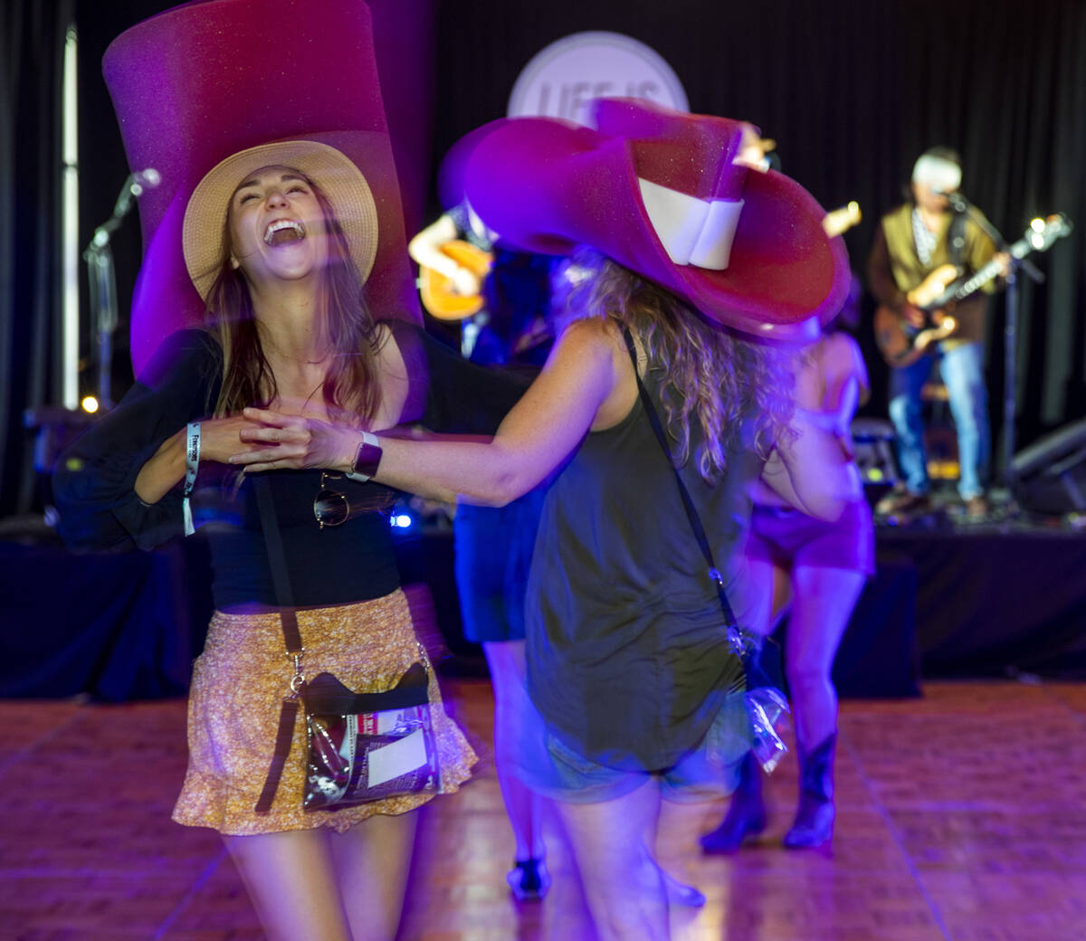 Beth Sassani, kiri, dan Kellie Brunty menari dengan topi koboi besar mereka saat The Rhyolite Sound ...