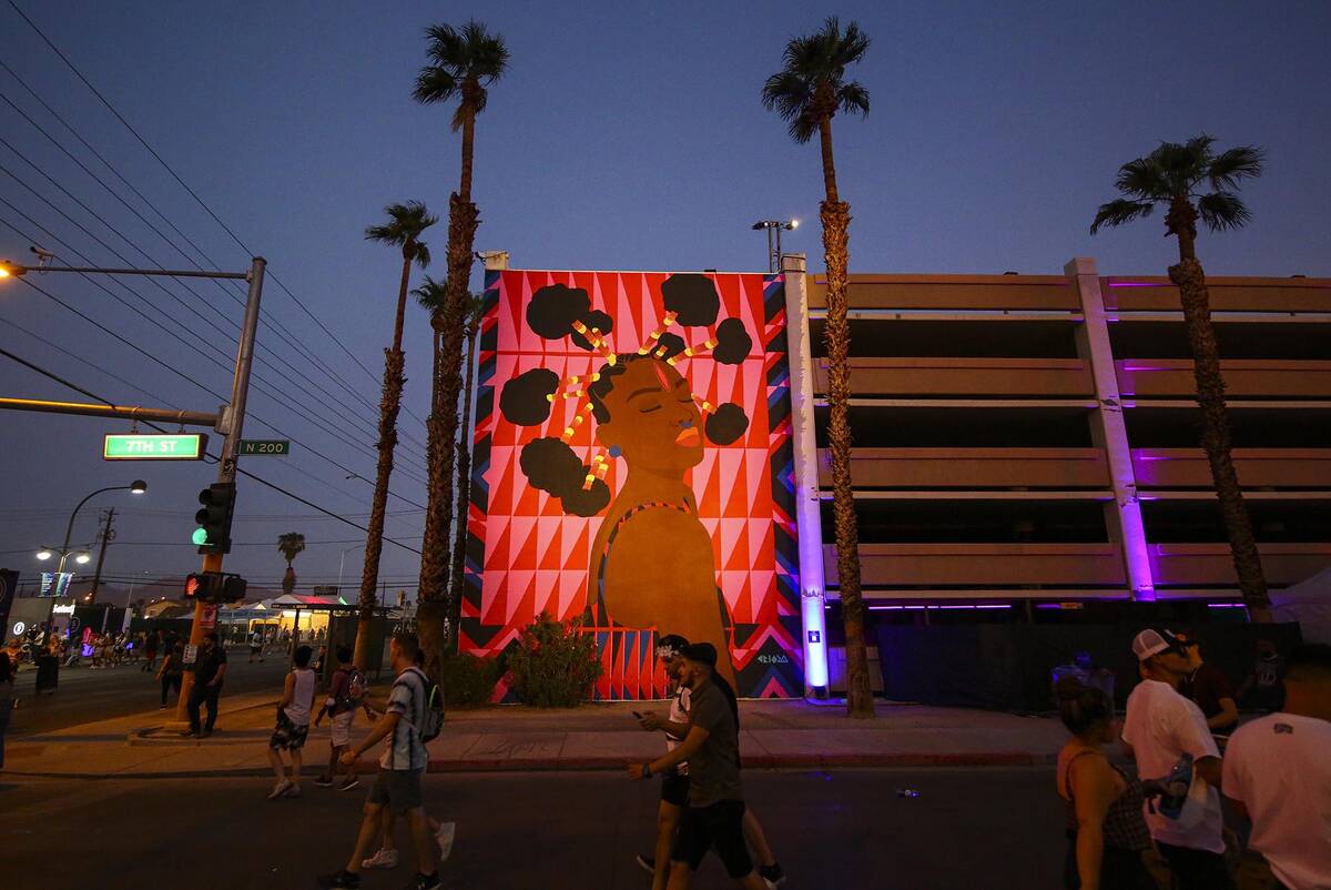 Attendees pass by a mural during the final day of the Life is Beautiful festival in downtown La ...