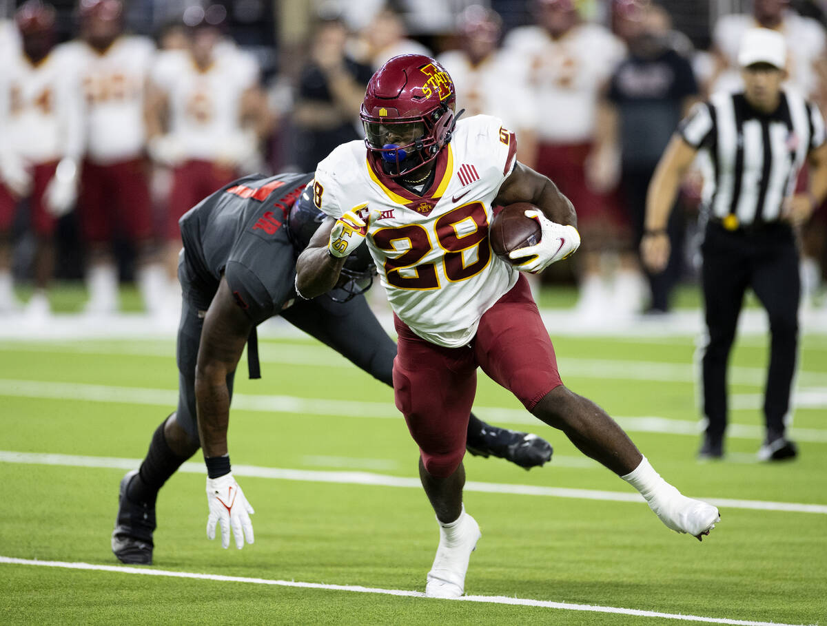 Iowa State CycloneÕs running back Breece Hall (28) runs past UNLV Rebels defensive line Ad ...