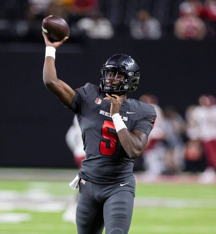 UNLV Rebels quarterback Justin Rogers (5) throws the ball as he warms up before an NCAA footbal ...