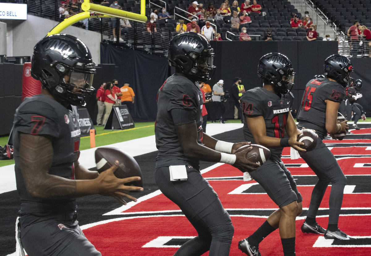 UNLV Rebels quarterbacks Cameron Friel (7) Justin Rogers (5) Jared Heywood (14) and Matthew Gee ...