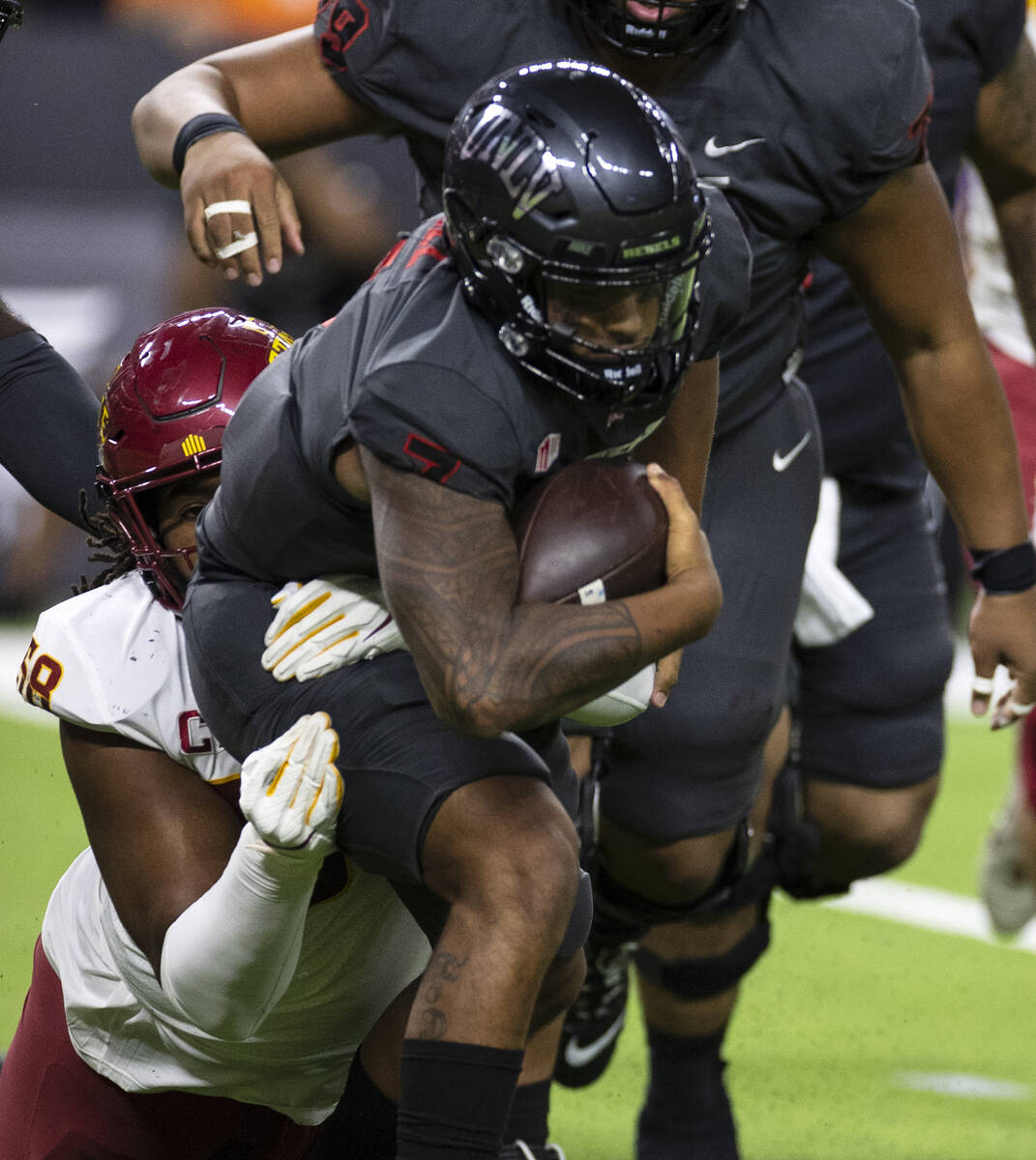 UNLV Rebels quarterback Cameron Friel (7) is sacked by Iowa State Cyclone’s defensive end Eyi ...