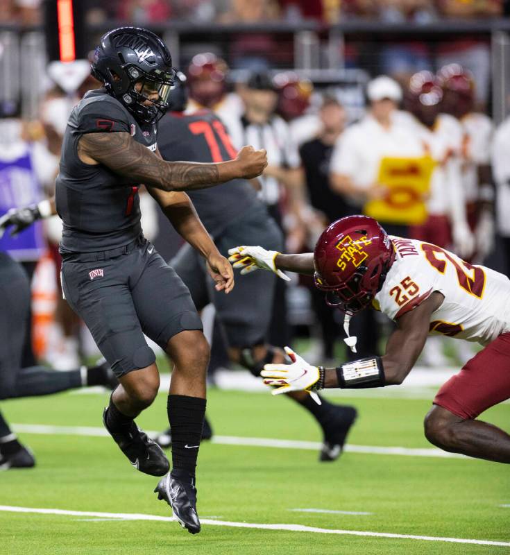 UNLV Rebels quarterback Cameron Friel (7) avoids a tackle from Iowa State Cyclone defensive bac ...