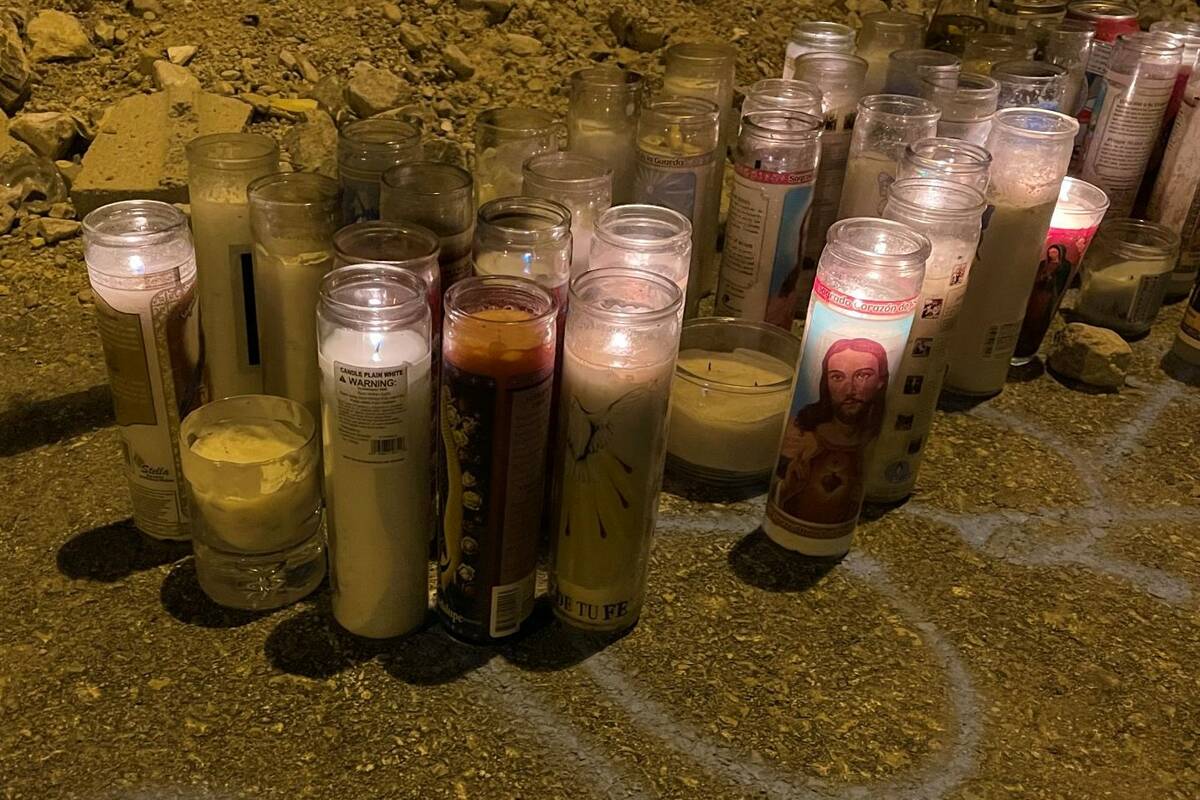 Dozens of candles in Summerlin mark the desert area where Ronald Munoz was found dead last mont ...