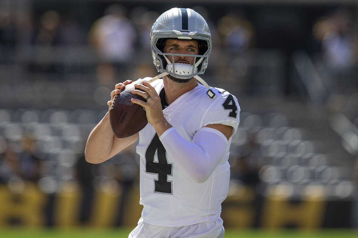 Raiders quarterback Derek Carr (4) warms up before an NFL football game on Sunday, Sept. 19, 20 ...