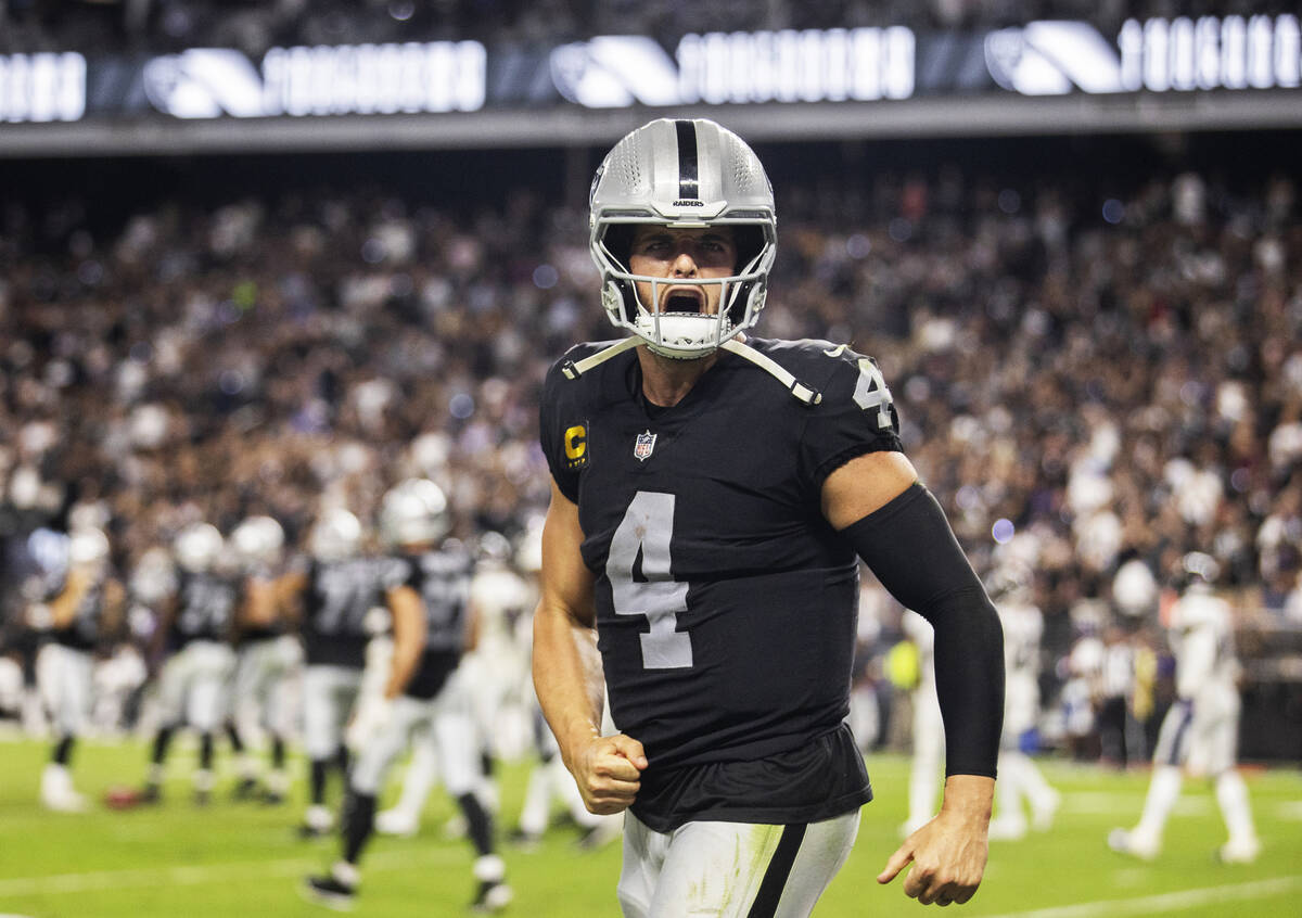 Raiders quarterback Derek Carr (4) celebrates a touchdown in the fourth quarter during an NFL f ...