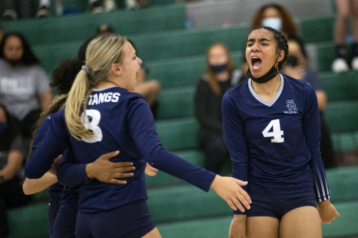 Shadow Ridge's Kylie Boyd (8) and Moni Jerome (4) celebrate a kill by their team during their h ...