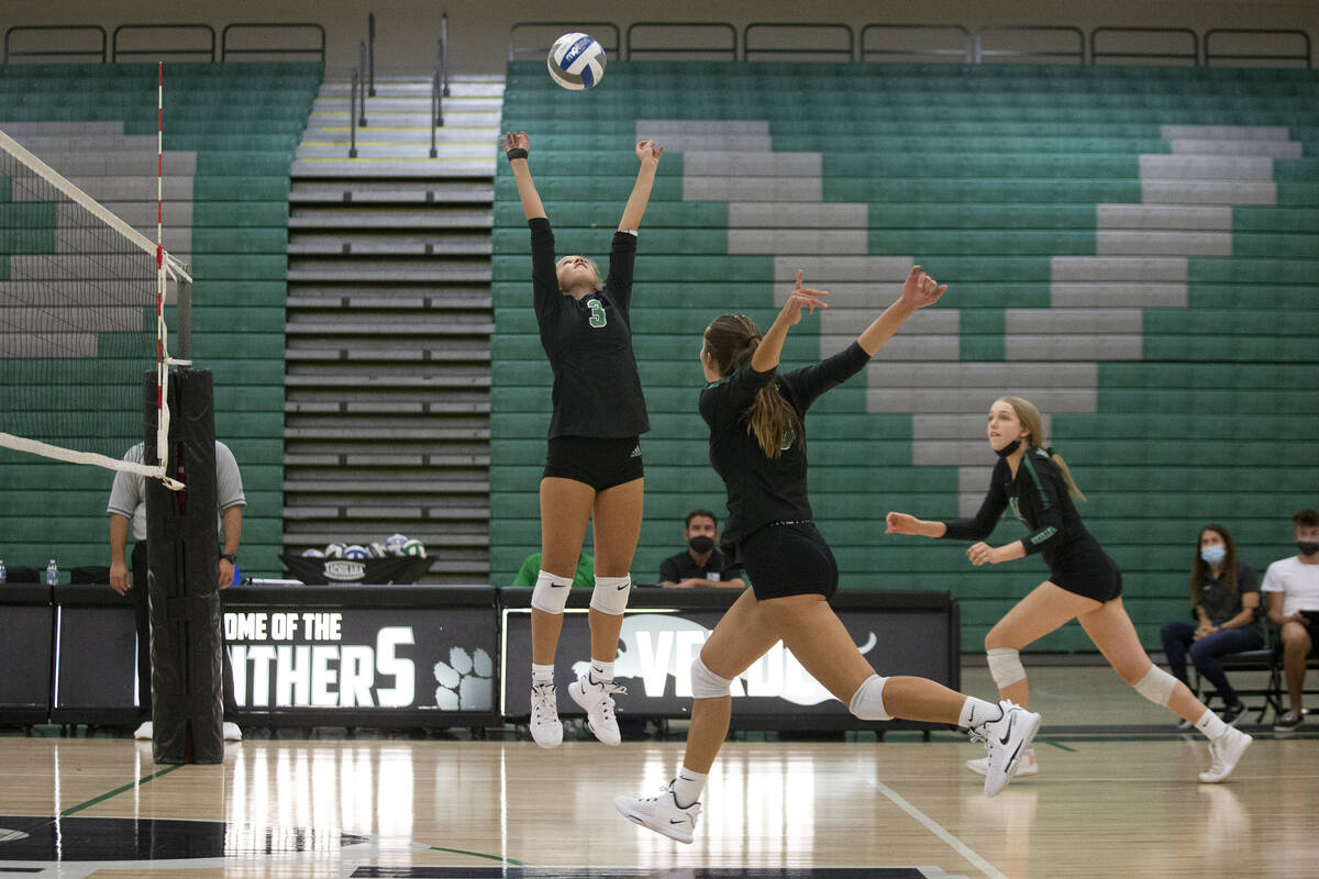 Palo Verde's C.J. Hausler (3) sets as her teammates Lincoln Common, center right, and Kate Camp ...