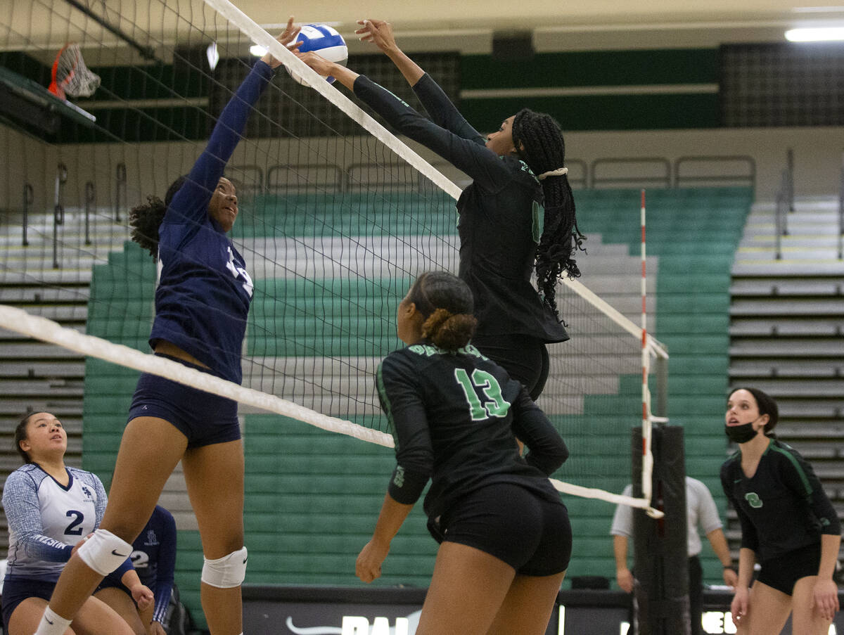 Palo Verde's Naomi White (8) kills a changeable  by Shadow Ridge's Jyniah Sanders (14) during their hullo   ...