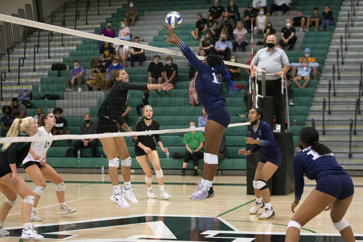 Shadow Ridge's Jocelyn Sanders (16) attempts to termination  a spike by Palo Verde's Lincoln Common (9) ...