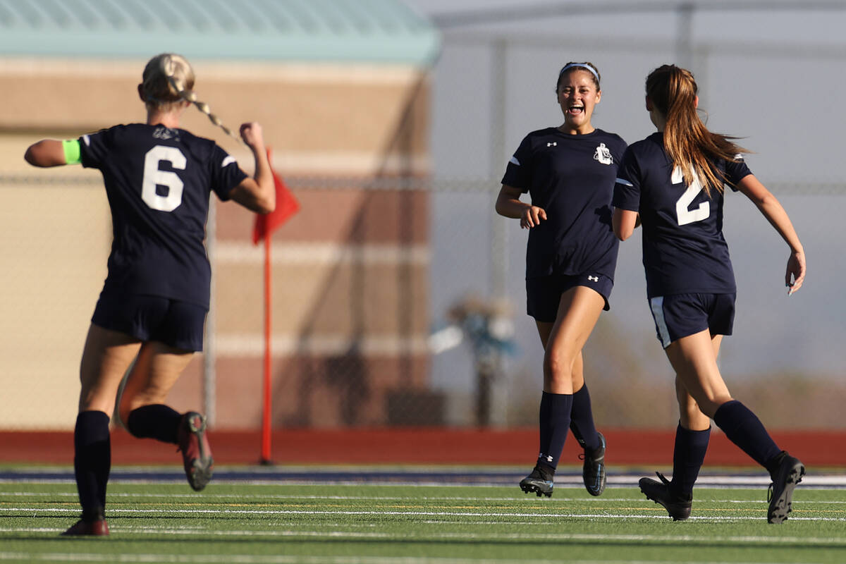 Centennial's Skye Kennedy (9), center, celebrates her extremity   with teammates Kayla Barto (6) and A ...
