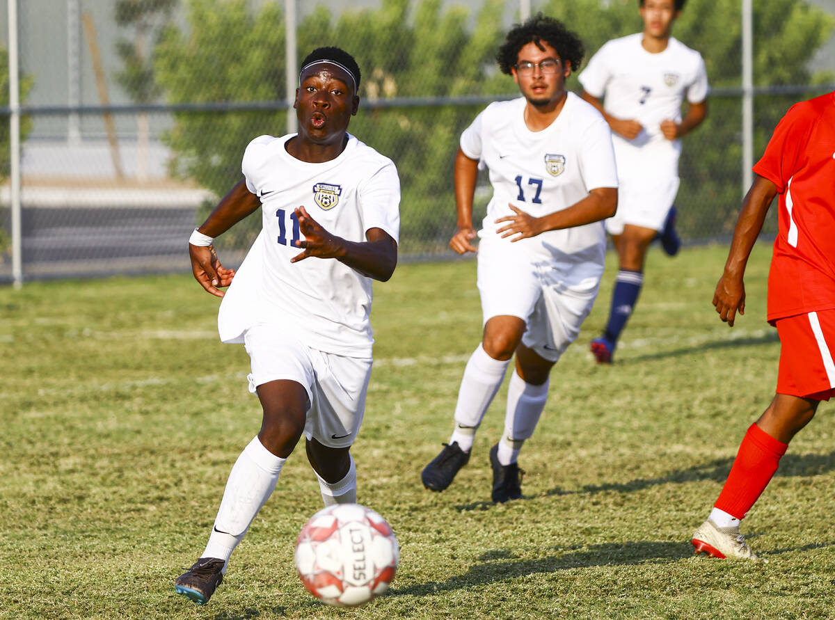 Spring Valley's Piyo Mulonda (11) moves the ball up the field during the first half of a soccer ...