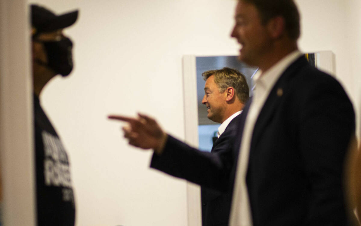 Former U.S. Sen. Dean Heller, right, talks with veteran Michael J. Clark while visiting Share V ...