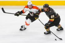 Golden Knights left wing William Carrier (28) moves the puck past Philadelphia Flyers center No ...