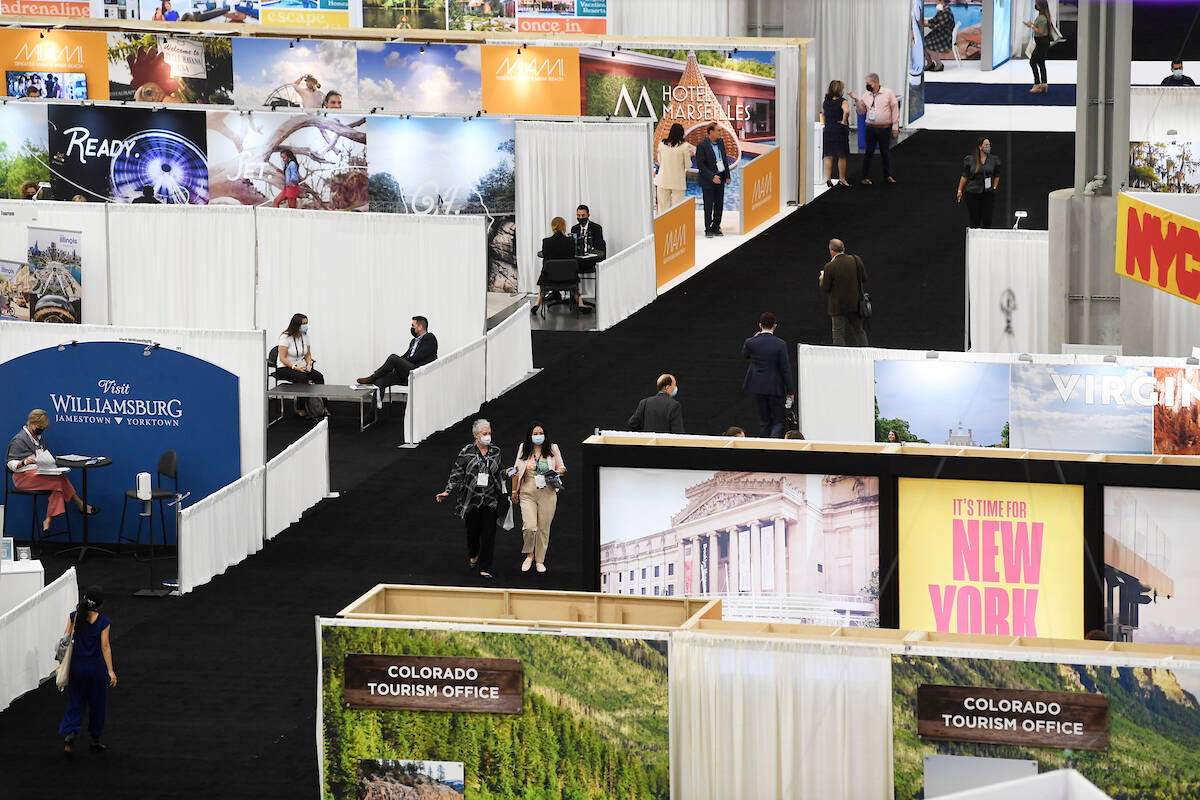 Vendors move around the show floor on the the opening day of the U.S. Travel Association's IPW ...