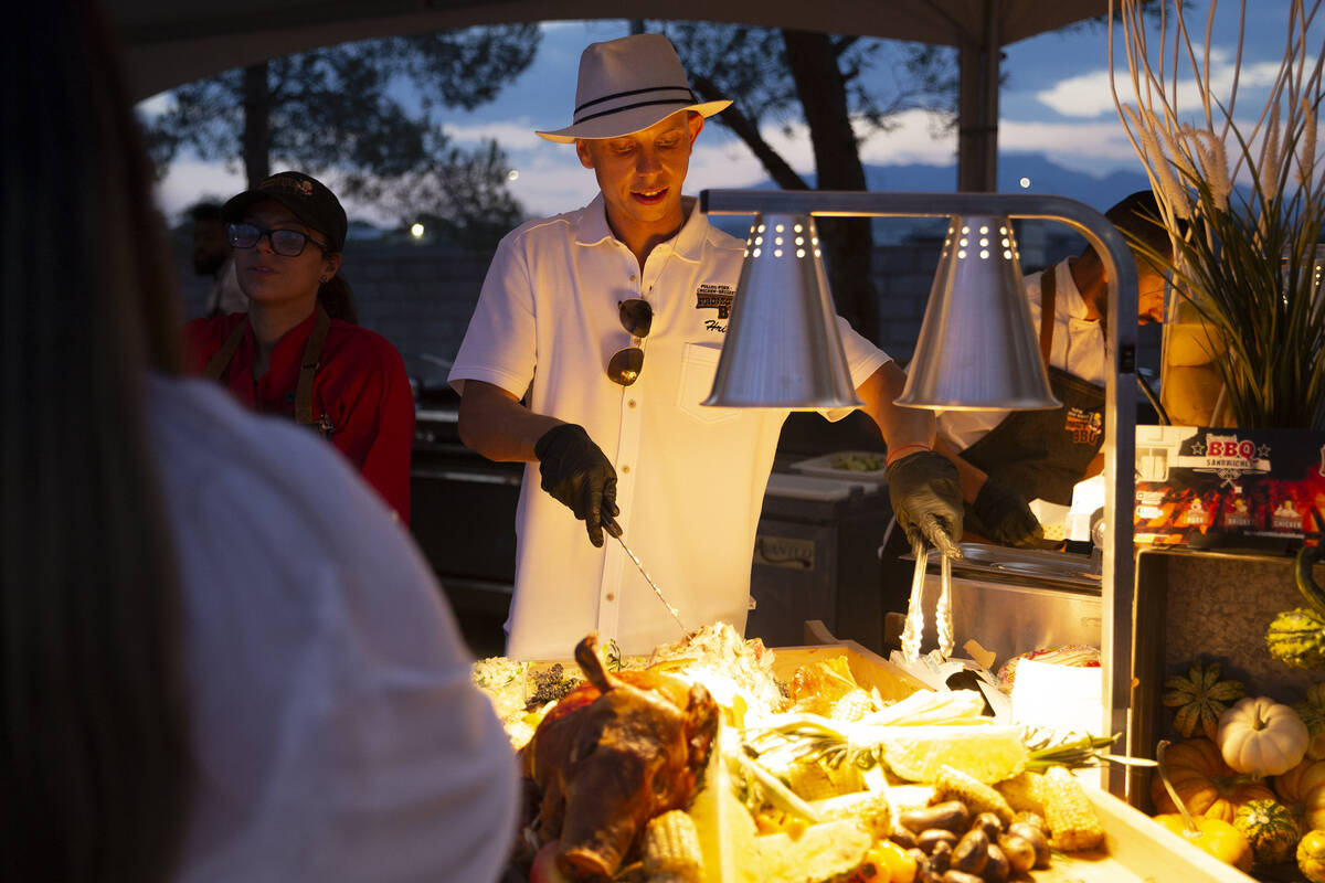 Hristo Velikov of Project BBQ Las Vegas makes a roast pork sandwich for a guest at the Night en ...