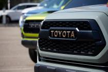 The company logo highlights the grille of a Tacoma pickup truck on display in the Toyota exhibi ...