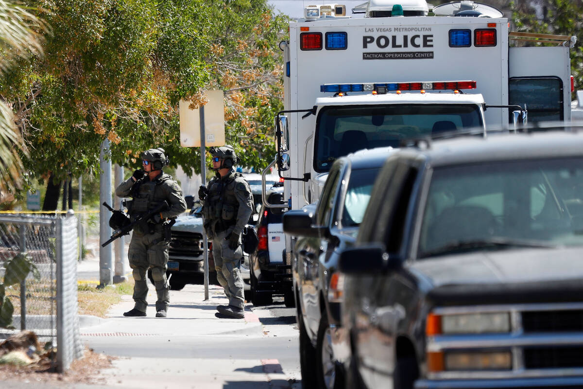 A heavy police presence is visible around the intersection of 10th Street and Lewis Avenue, Tue ...