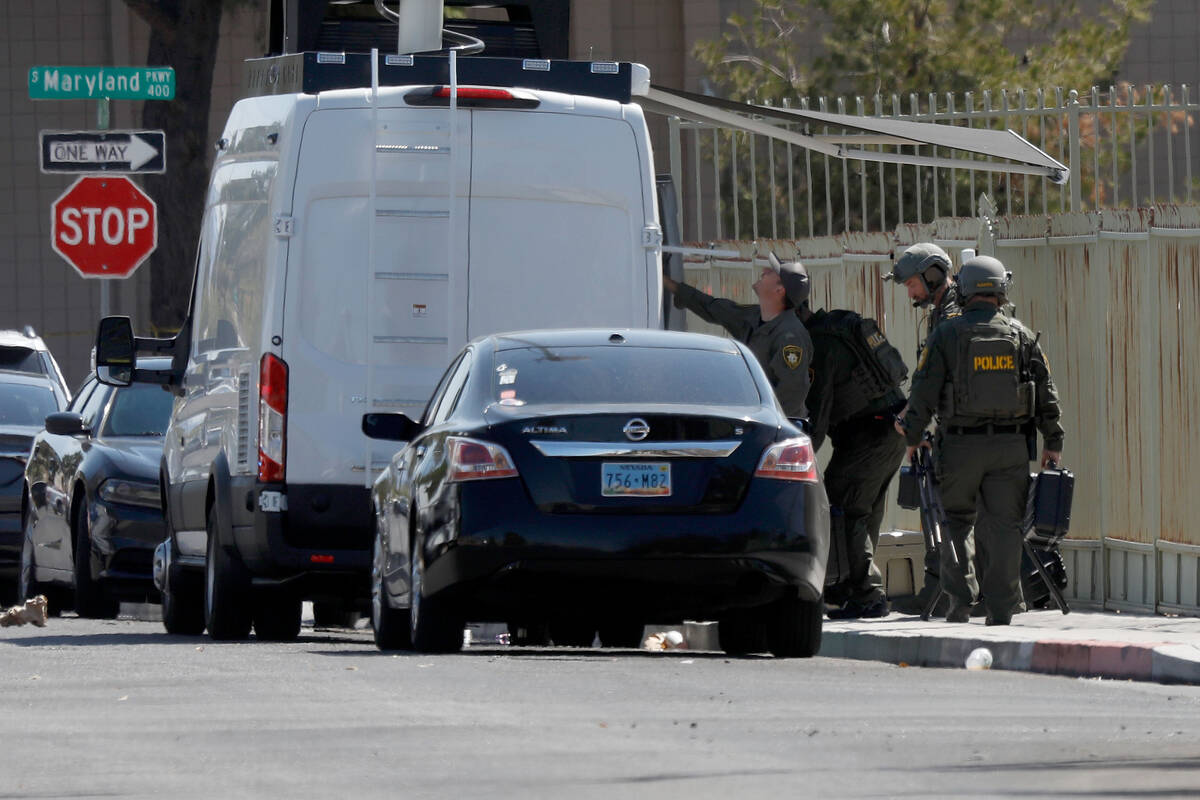 A heavy police presence is visible around the intersection of 10th Street and Lewis Avenue, Tue ...