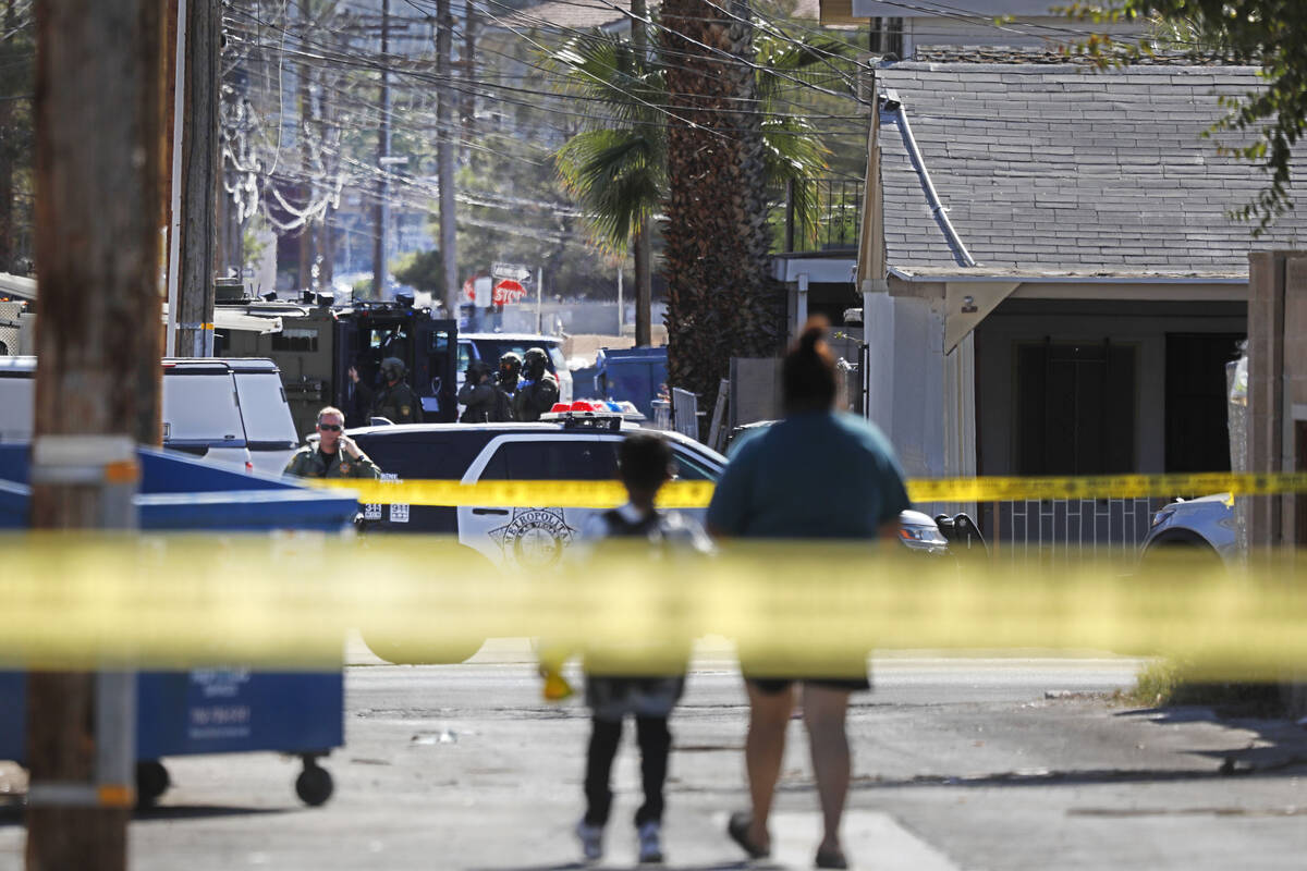 A heavy police presence is visible around a house in the 300 block of South 11th Street, Tuesda ...