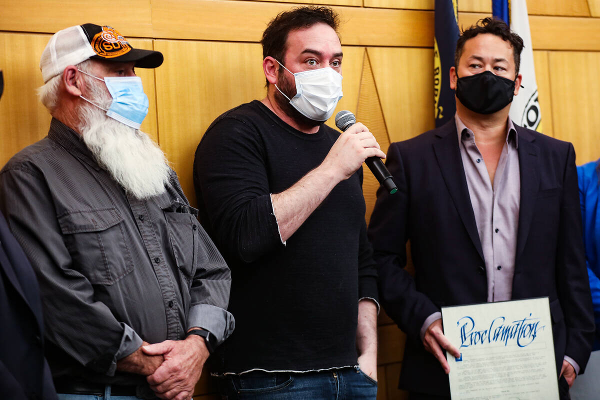Othram CEO David Mittelman, center, speaks as John Isaacson, left, and Justin Woo, right, look ...